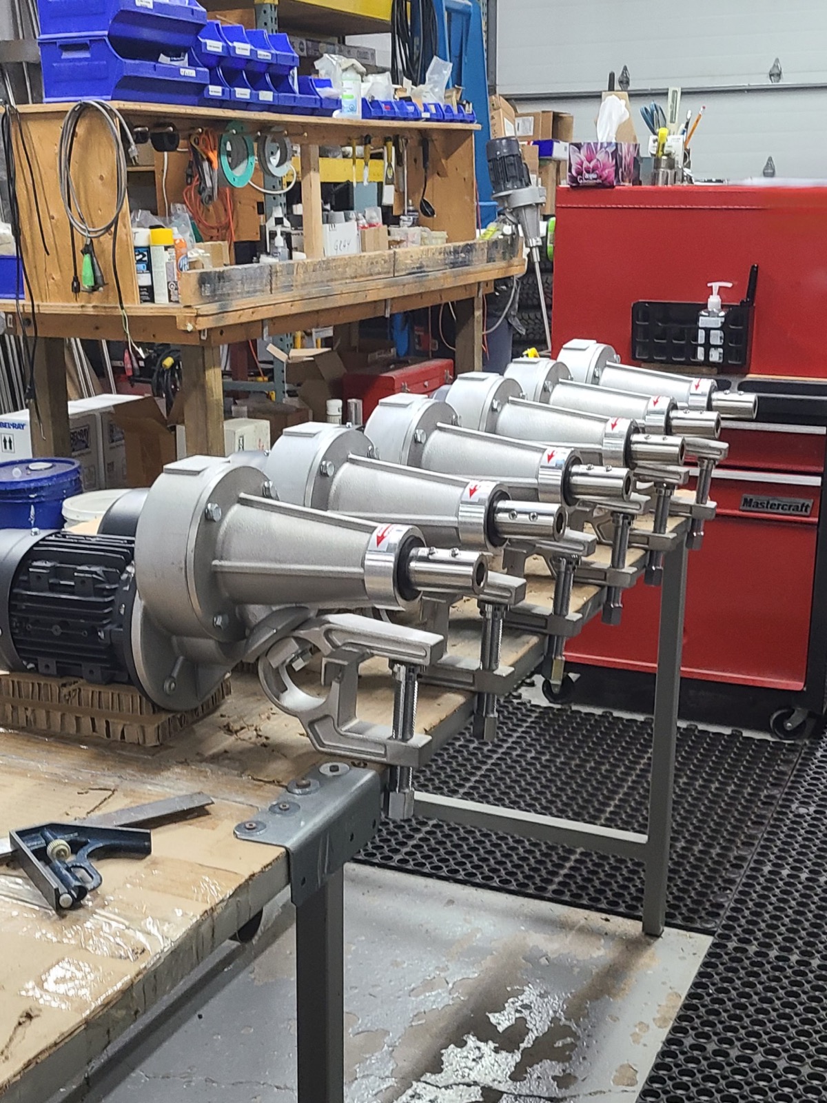 Lineup of Delta flange mount mixers on the workshop bench